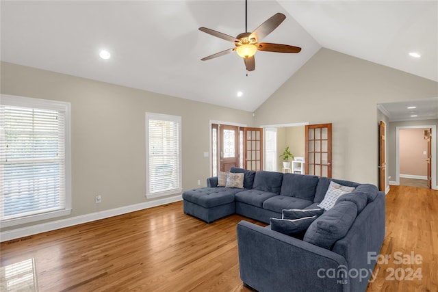 living room with french doors, light wood-type flooring, high vaulted ceiling, and ceiling fan