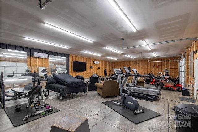 workout area with a wall unit AC and wooden walls