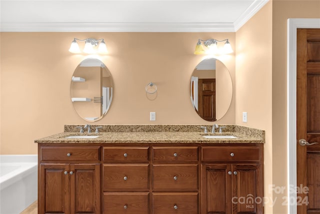 bathroom with vanity, a bathtub, and ornamental molding