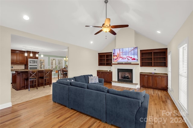 living room featuring a wealth of natural light, light hardwood / wood-style flooring, and ceiling fan