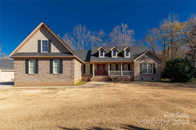 view of front of property featuring an outbuilding, a porch, and a garage