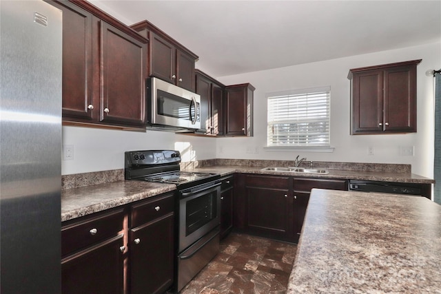 kitchen with dark brown cabinetry, stainless steel appliances, and sink