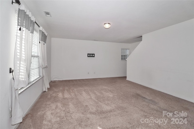 empty room with light colored carpet