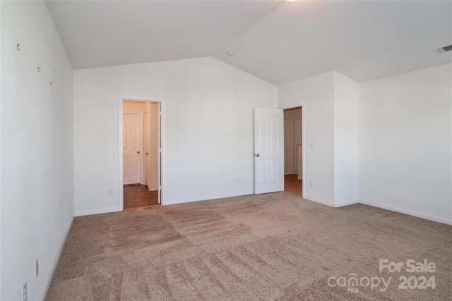 unfurnished bedroom featuring carpet floors and lofted ceiling