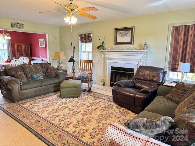 living room featuring ceiling fan and a high end fireplace