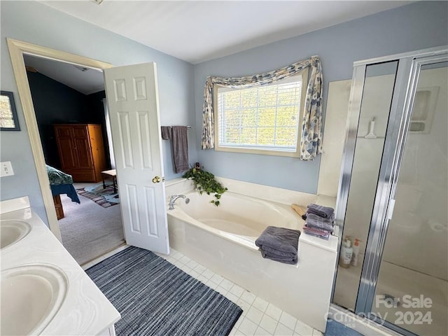 bathroom featuring tile patterned floors, vanity, separate shower and tub, and vaulted ceiling