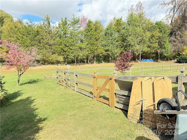 view of gate featuring a yard and a rural view