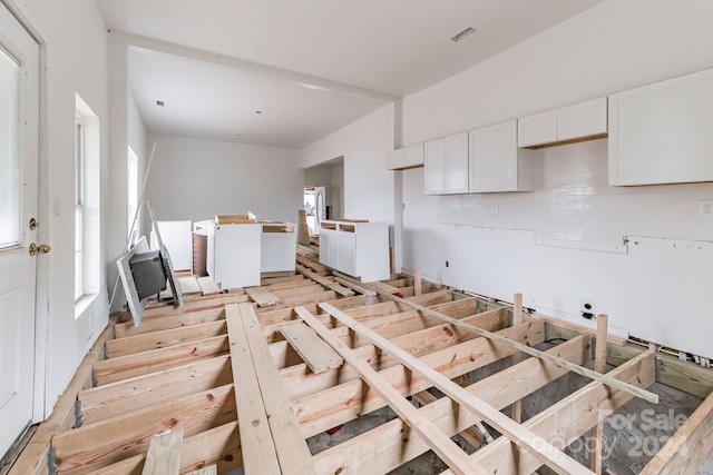 kitchen featuring decorative backsplash and white cabinets