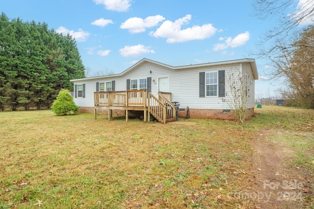 back of property featuring a yard and a deck