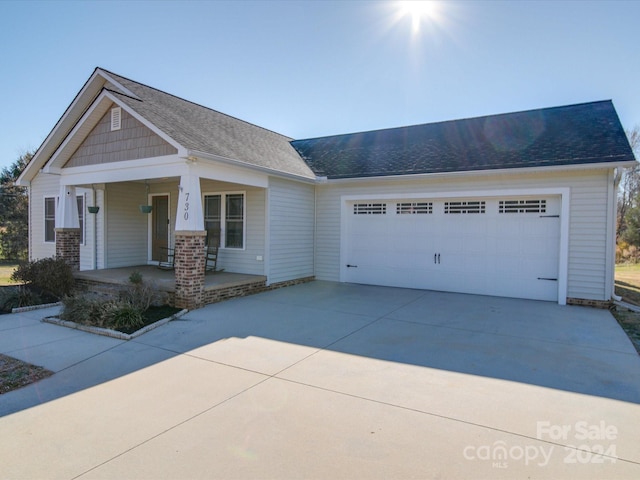 craftsman house with covered porch and a garage