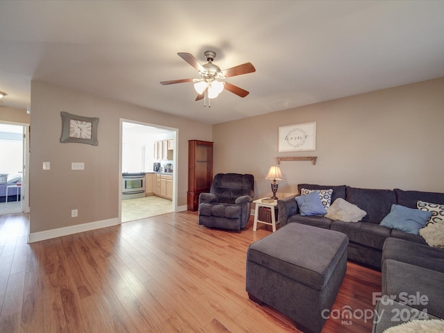 living room featuring hardwood / wood-style flooring and ceiling fan