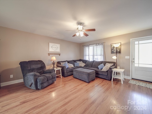 living room with ceiling fan and light hardwood / wood-style flooring