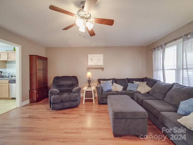 living room featuring ceiling fan and light wood-type flooring