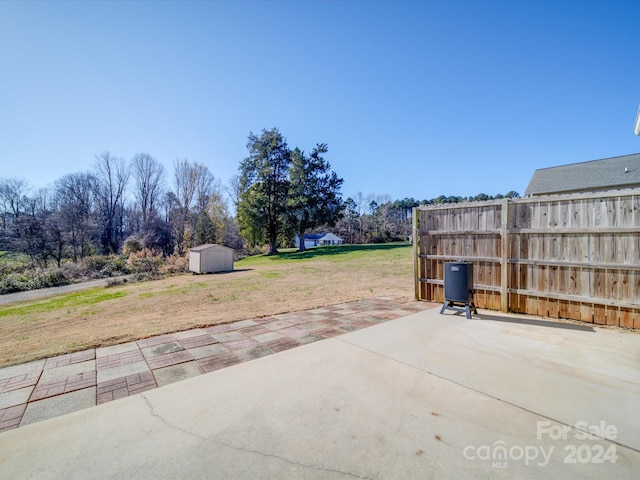 view of patio with a storage shed