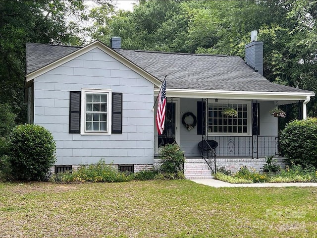 bungalow with a porch and a front yard