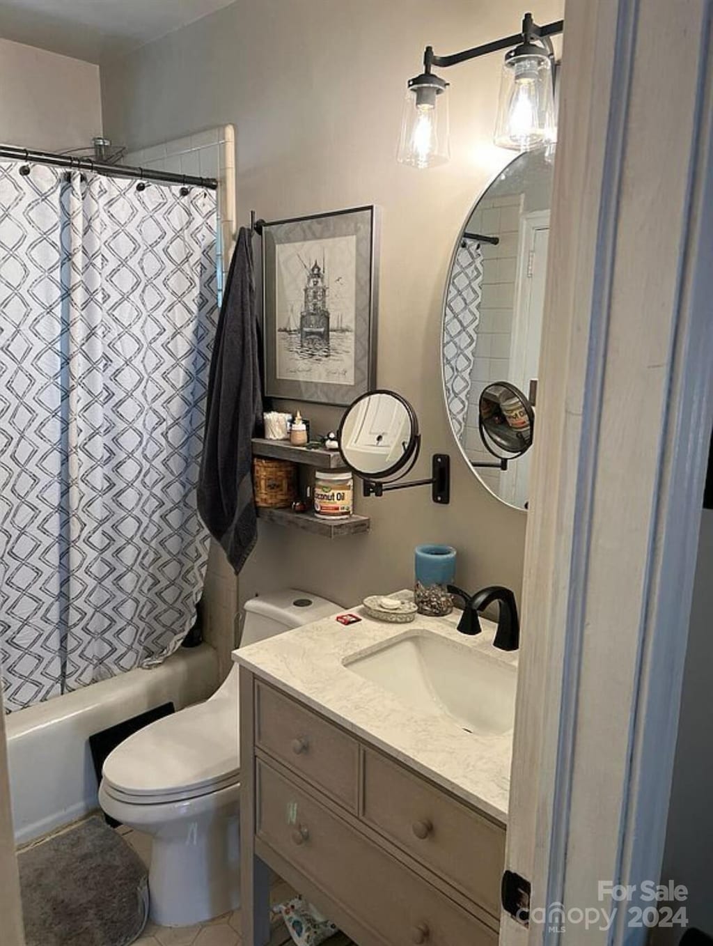 full bathroom featuring shower / bath combination with curtain, vanity, toilet, and tile patterned floors