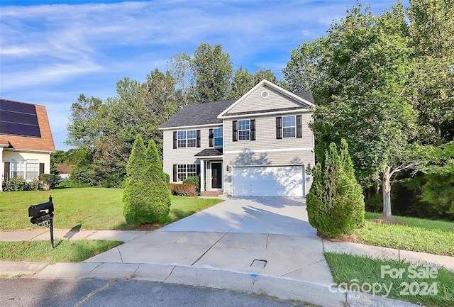 view of front facade with a front yard and a garage