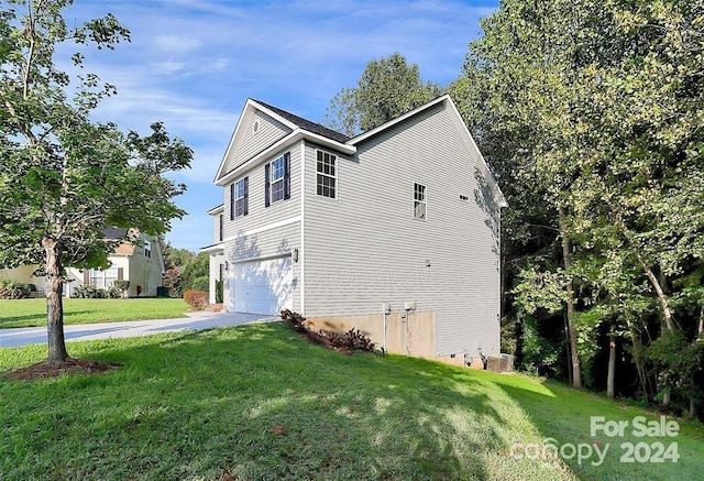 view of property exterior featuring a lawn, cooling unit, and a garage