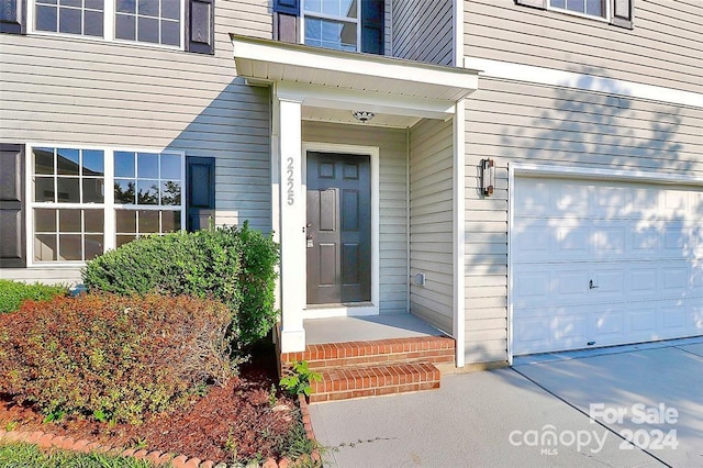 view of exterior entry with a garage