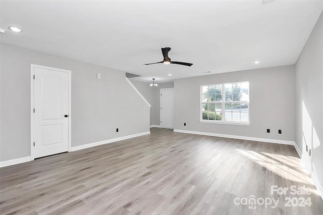 unfurnished living room with ceiling fan and light hardwood / wood-style flooring