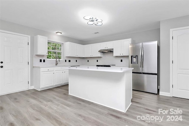 kitchen with light hardwood / wood-style floors, a kitchen island, white cabinetry, and stainless steel refrigerator with ice dispenser