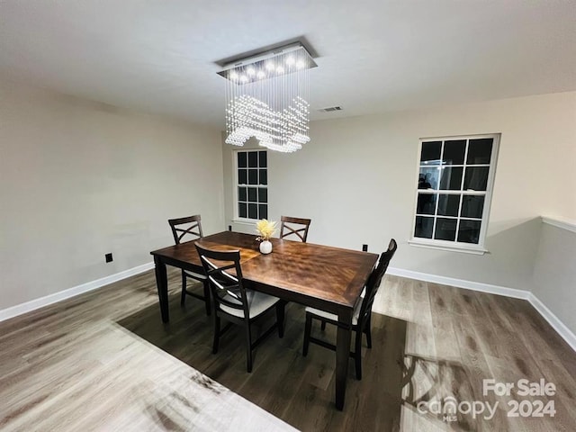 dining area featuring a chandelier and hardwood / wood-style flooring