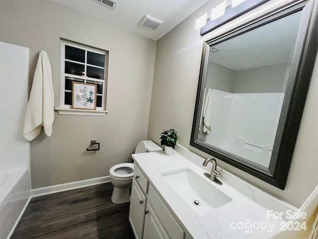 full bathroom featuring shower / tub combination, vanity, wood-type flooring, and toilet