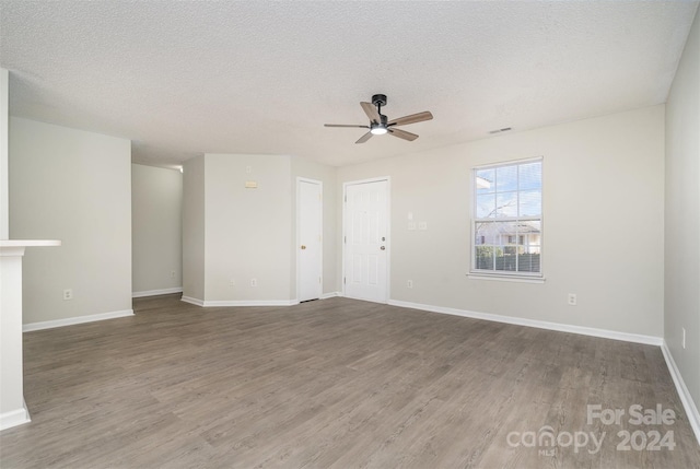 unfurnished living room featuring ceiling fan, a textured ceiling, and hardwood / wood-style flooring