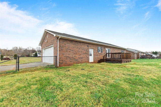 view of property exterior featuring a lawn, a garage, and a deck