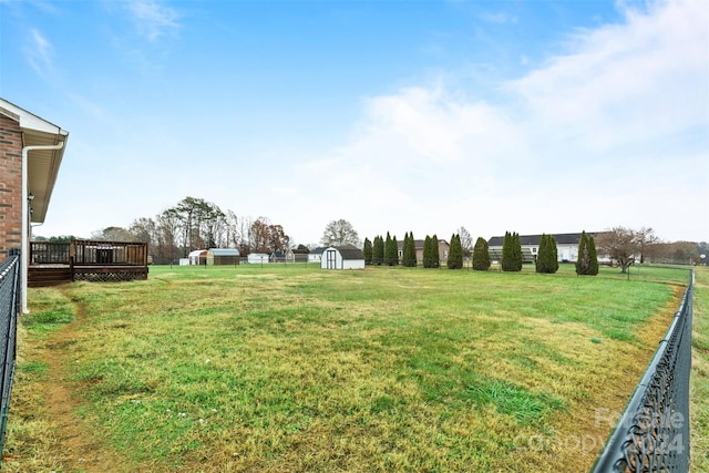 view of yard with a shed and a wooden deck