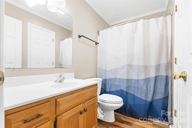 bathroom with hardwood / wood-style floors, vanity, toilet, ornamental molding, and walk in shower