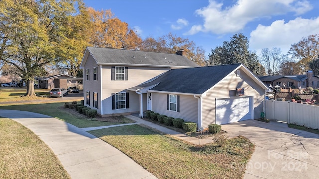 view of front of house with a garage and a front yard