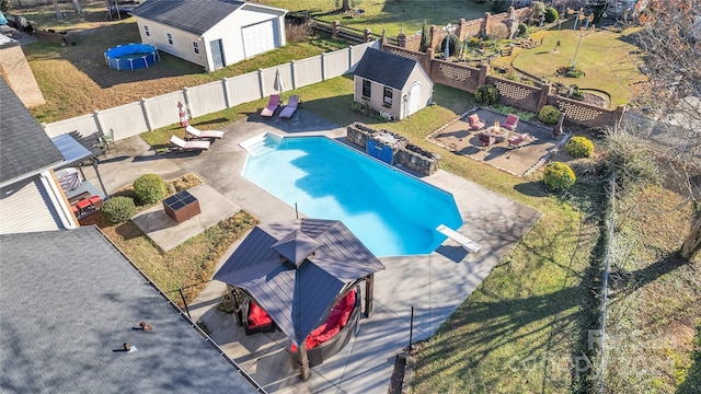 view of swimming pool with an outbuilding, a gazebo, a diving board, and a patio area