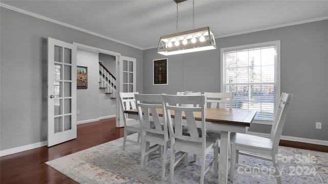 dining area with ornamental molding, french doors, and dark wood-type flooring