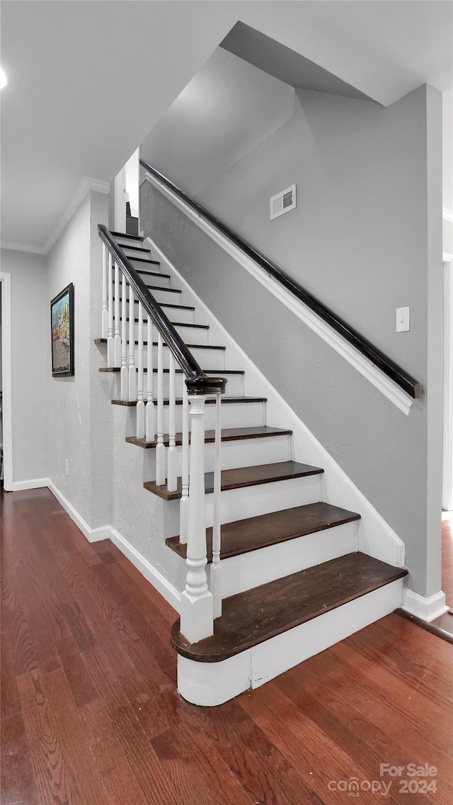 stairway featuring wood-type flooring