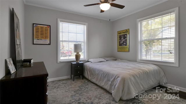 bedroom featuring multiple windows, crown molding, and ceiling fan