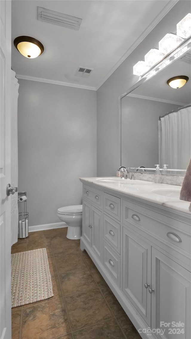 bathroom featuring vanity, toilet, and crown molding