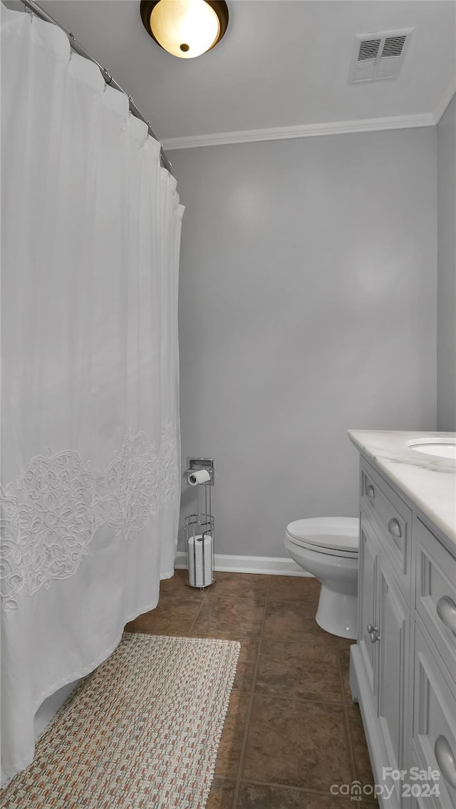 bathroom featuring tile patterned floors, vanity, toilet, and ornamental molding