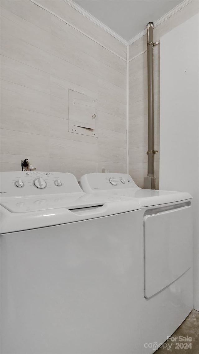 laundry area featuring independent washer and dryer and ornamental molding