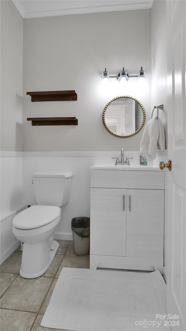 bathroom featuring tile patterned floors, vanity, toilet, and ornamental molding