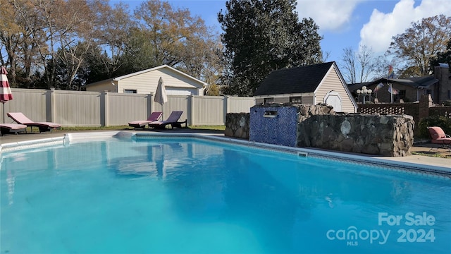 view of swimming pool with an outdoor structure