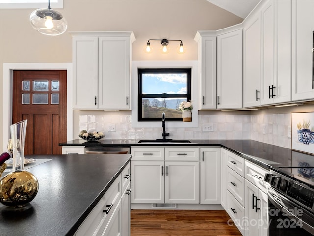 kitchen with backsplash, sink, decorative light fixtures, dark hardwood / wood-style floors, and white cabinetry