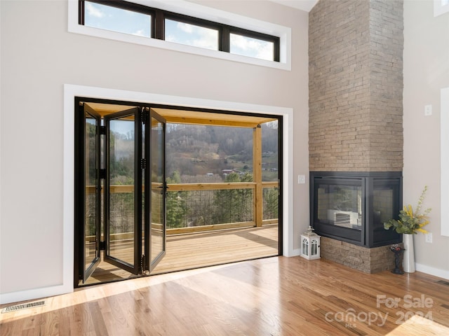 154 Aster Ridge Dr, Waynesville, NC 28786 - entryway featuring a high ceiling, wood finished floors, and a stone fireplace