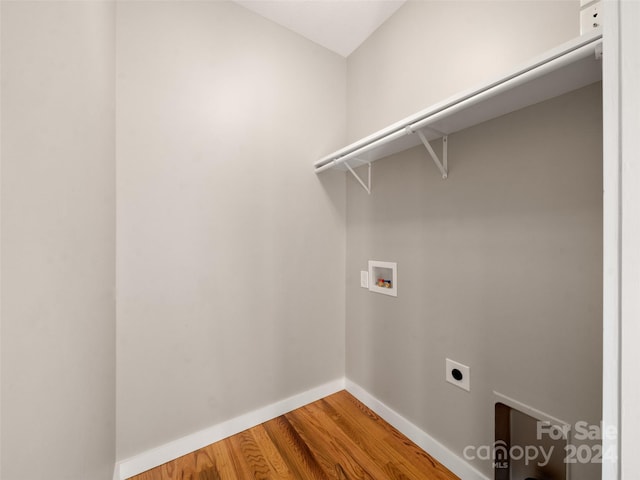 laundry area with hardwood / wood-style flooring, electric dryer hookup, and washer hookup