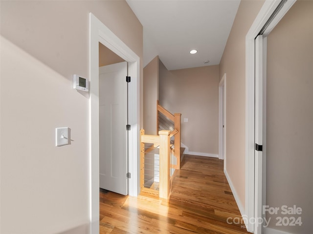 corridor with light hardwood / wood-style floors