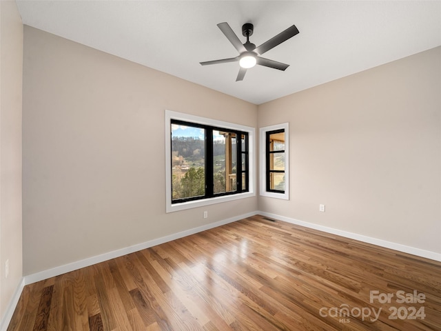 unfurnished room featuring hardwood / wood-style flooring and ceiling fan