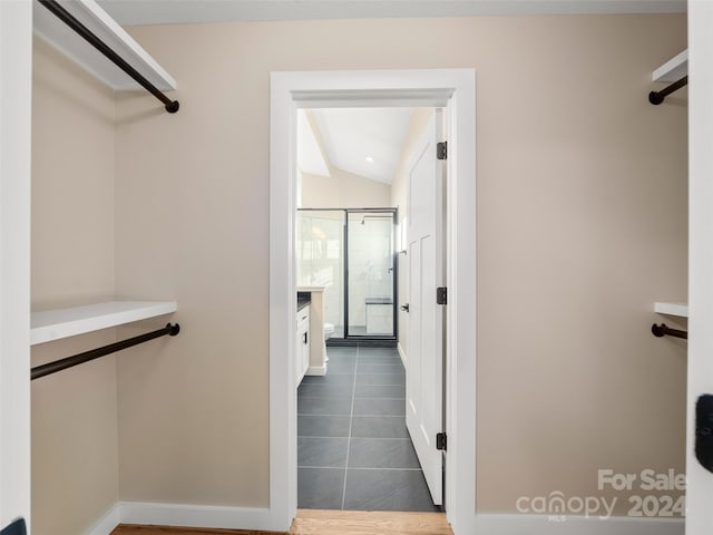 154 Aster Ridge Dr, Waynesville, NC 28786 - walk in closet featuring lofted ceiling and dark tile patterned flooring