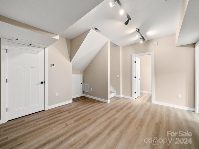 additional living space featuring light hardwood / wood-style flooring