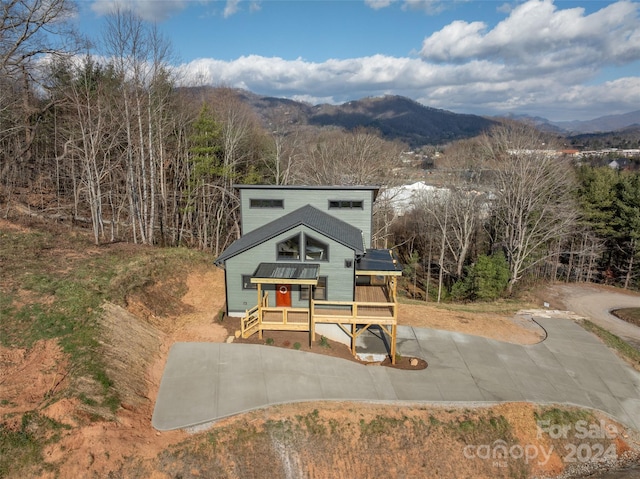 view of front of property featuring a deck with mountain view