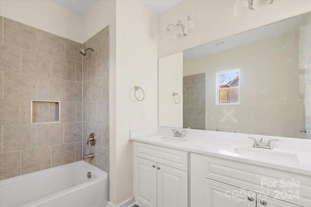 bathroom with vanity and tiled shower / bath